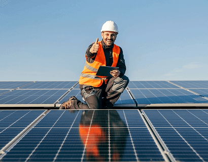 Solar technician inspecting a large panel array