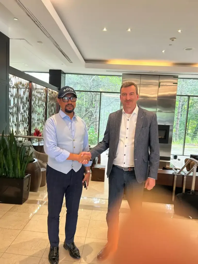 Two business representatives shaking hands indoors