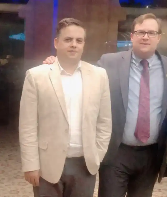Two business representatives standing together at an event