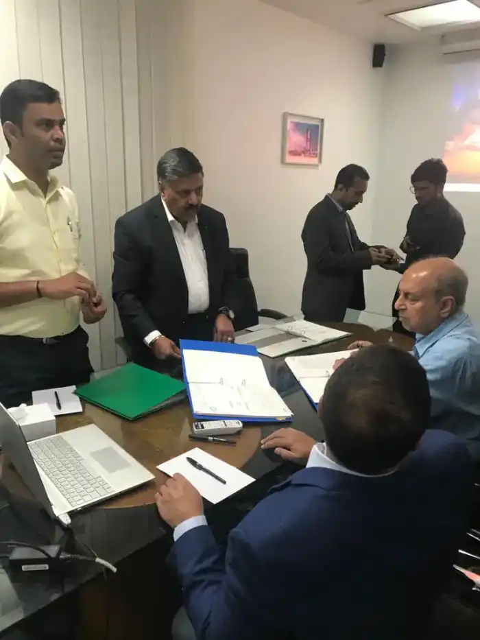 Colleagues reviewing documents around a conference table