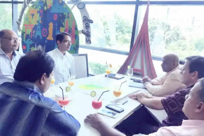Group discussion around a table beside a large window