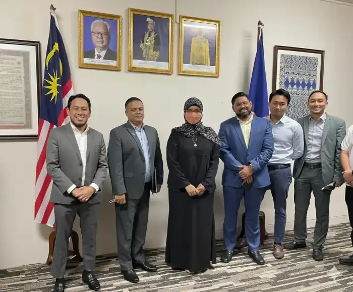 Group of business representatives posing together in an office