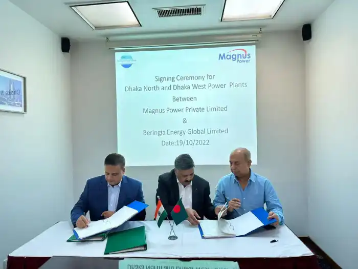 Representatives signing documents at a power project ceremony
