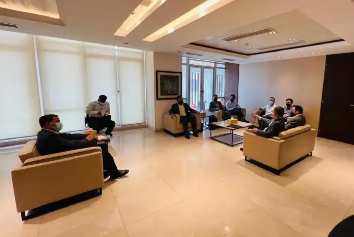 Participants seated for a meeting in an office lounge