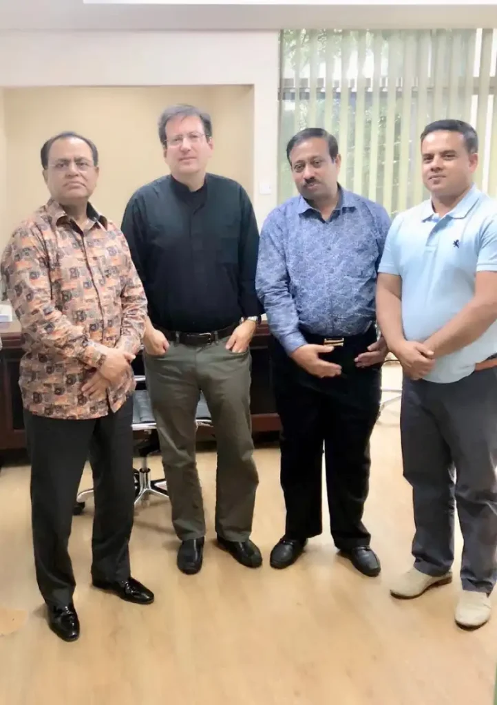 Four business representatives posing together in an office