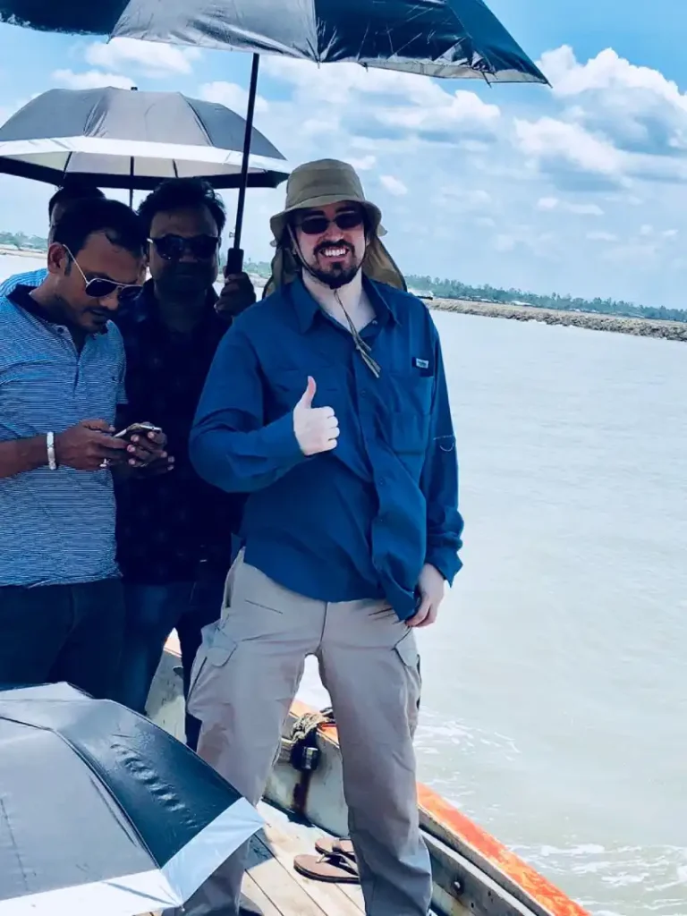 Visitor standing on a boat during a site visit