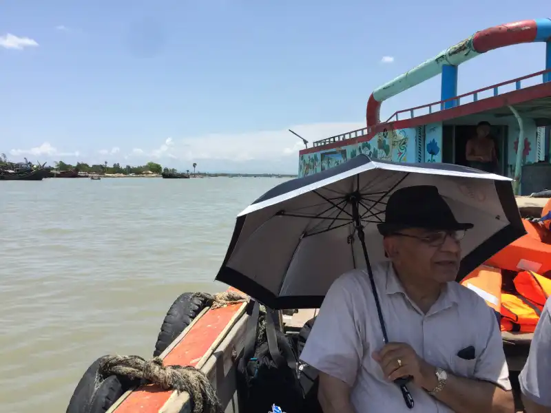Visitor holding an umbrella on a boat