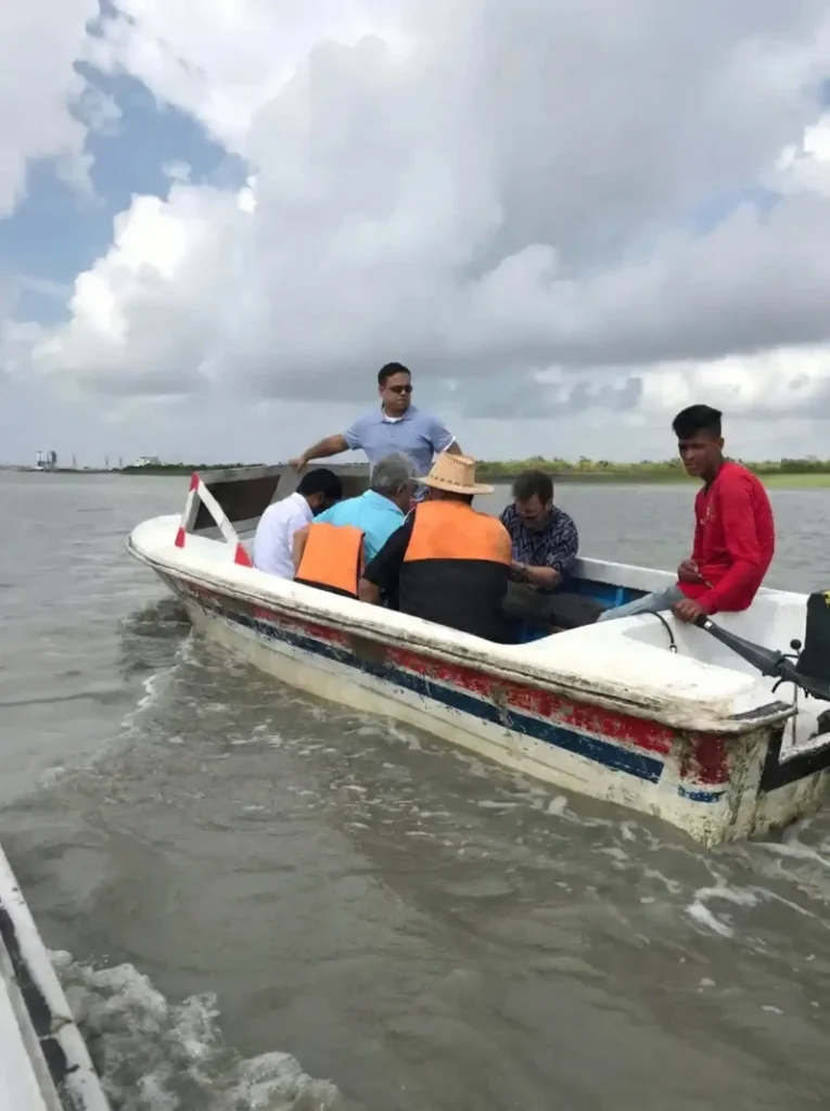 Inspection team crossing a waterway in a small boat