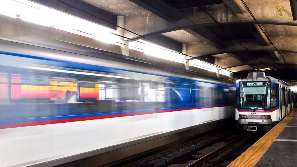 Passenger trains passing through a railway station