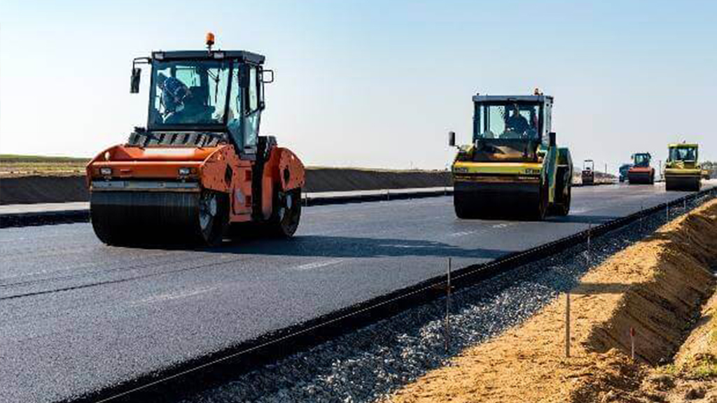 Road rollers paving a new highway