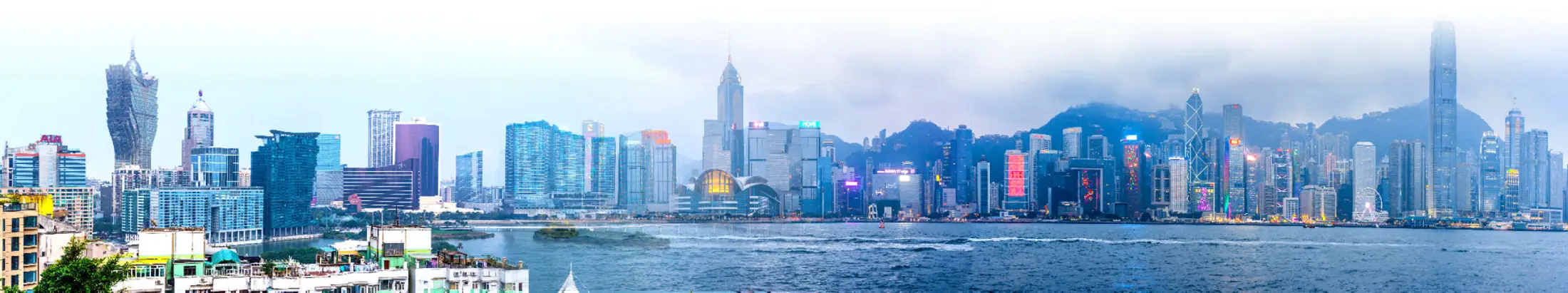 Panoramic city skyline across a harbor