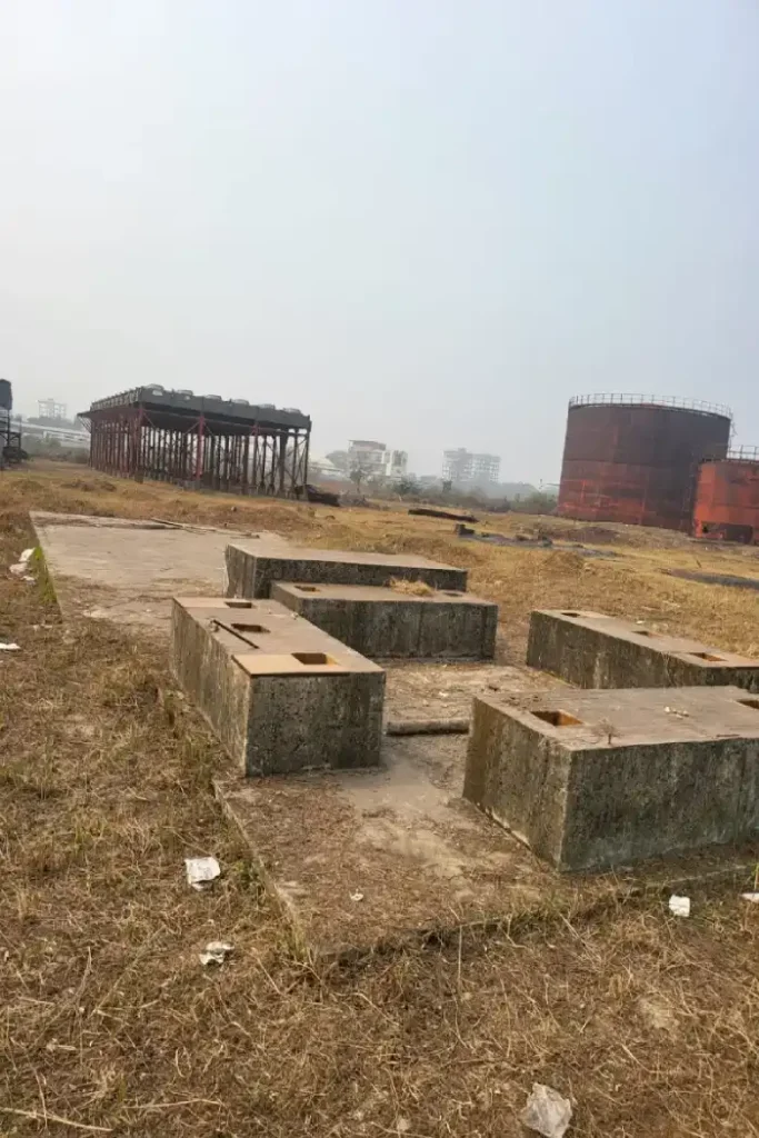 Concrete foundations and storage tanks at an industrial site