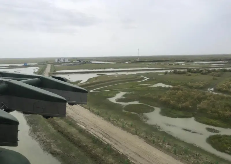 Aerial view of wetlands and a road near a project area