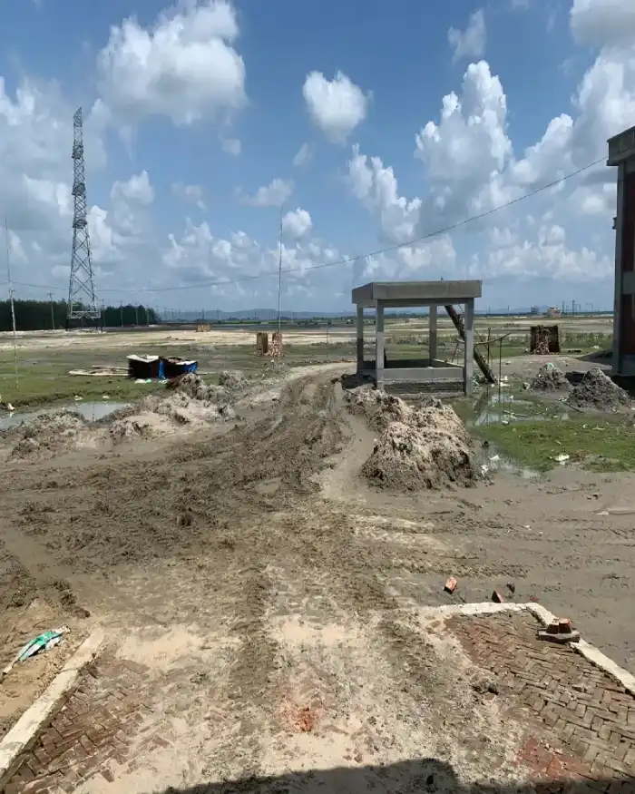 Open project land with a small structure and utility tower