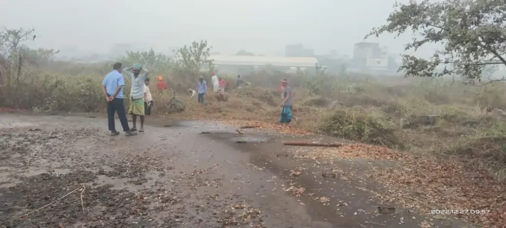 Workers on a road near cleared project land